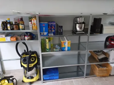 Compact metalen opbergrek met lage afmetingen, geschikt voor lage ruimtes zoals een voorraadkast of kelder.